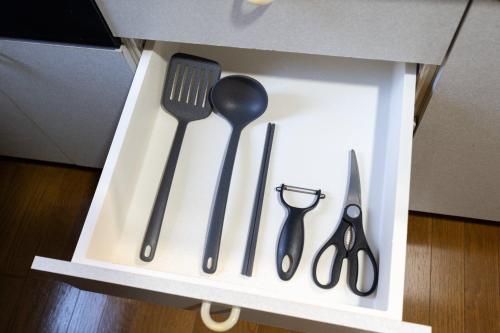 a drawer filled with utensils in a box at The Nekozane HAUS in Urayasu