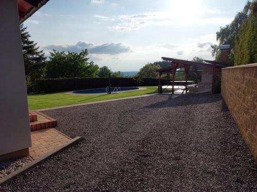 a gravel driveway with a park in the background at Chalupa Trosenka in Troskovice