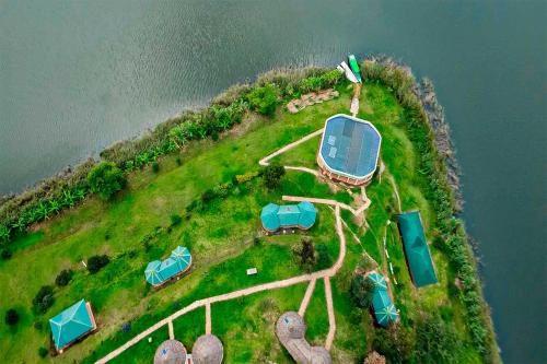 an island with tents on it next to the water at Nyamunyonyi Lake Resort in Kabale