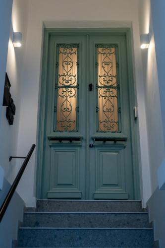a green door with stairs in a house at Τhe 1930s in Mytilini