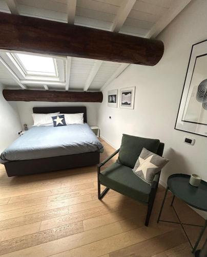 a bedroom with a bed and a chair at City Soul in Salò