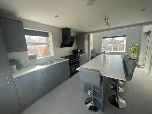 a kitchen with a counter and a sink and a stove at Newton house in Burton Fleming
