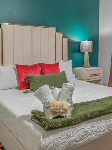 a bed with a basket of towels and teddy bears at Groovy, New & Modern! Tv in each room in Shreveport