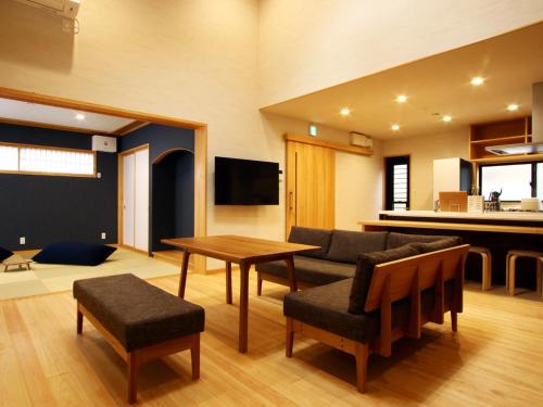 a living room with a couch and a table at 箱根リゾート yamaki in Hakone