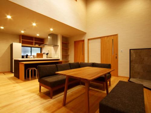 a living room with a table and a couch at 箱根リゾート yamaki in Hakone
