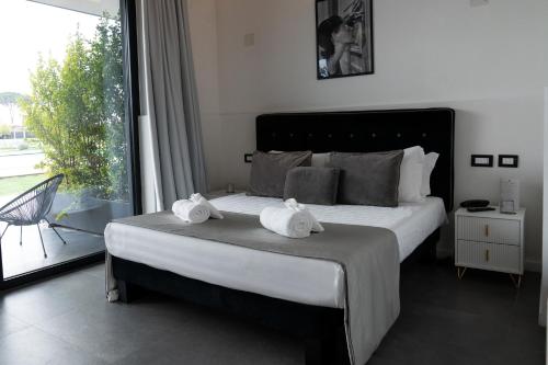 a bedroom with a large bed with towels on it at Secret Garden Resort & Spa in Palma Campania