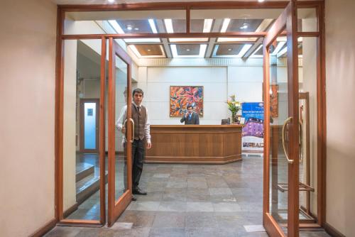 a man standing in the doorway of a lobby at Gran Hotel Isabel Riquelme in Chillán