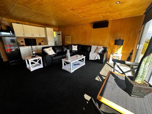 a living room with a couch and a table at Moana Lakeview Chalet in Moana