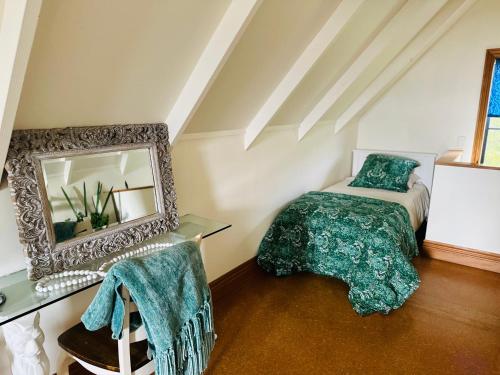 a bedroom with a bed and a mirror at Moana Lakeview Chalet in Moana