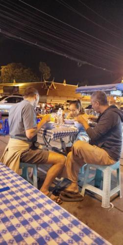 a group of men sitting at a table at Bannuea Local Life in Ban Nam Lat