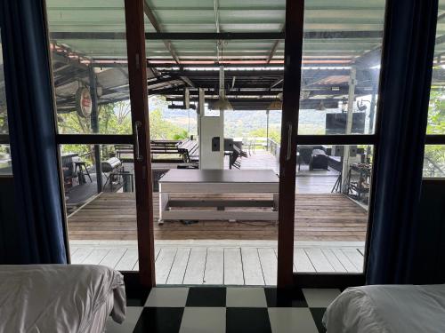a room with a table on a wooden deck at บ้านเชิงเขา โฮมสเตย์ in Ban Mai