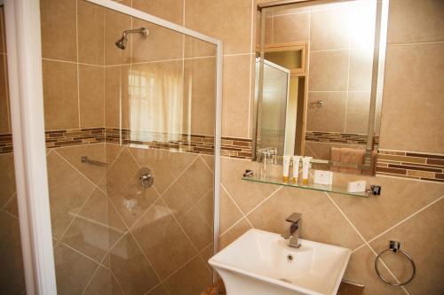 a bathroom with a shower and a sink at Blyde Canyon, A Forever Resort in Matibidi