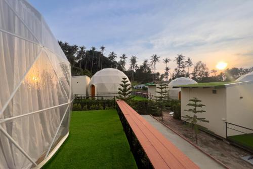a view of a house with a lawn and domes at Sunny Side Resort Koh Tao in Koh Tao
