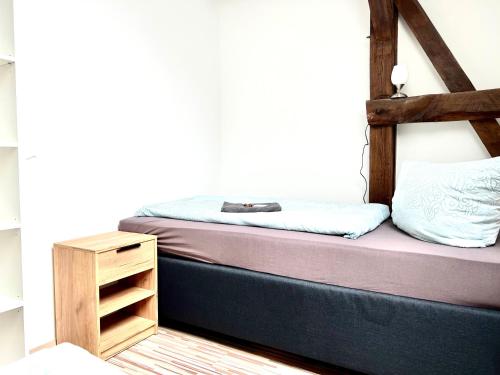 a bedroom with a bunk bed and a night stand at Ferienwohnung in Schkeuditz in Schkeuditz