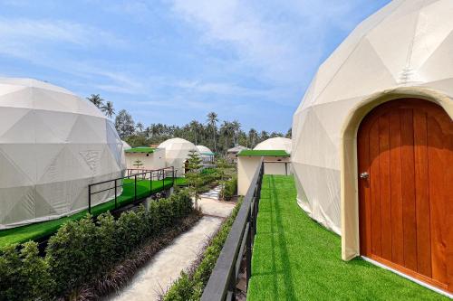 an exterior view of a luxury dome house with a wooden door at Sunny Side Resort Koh Tao in Koh Tao