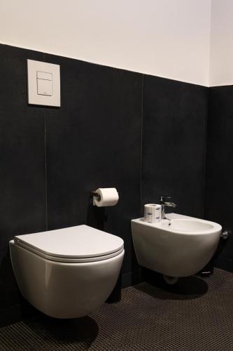a bathroom with a white toilet and a sink at Secret Garden Resort & Spa in Palma Campania