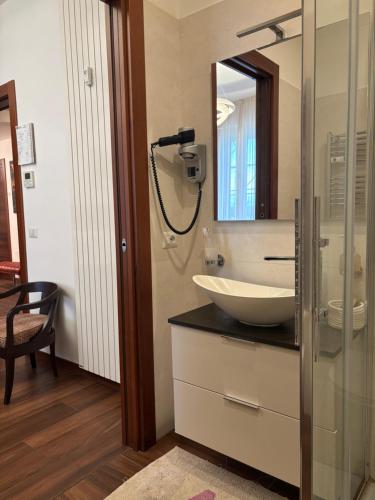 a bathroom with a sink and a mirror at Enjoy Milano Skyline in Milan