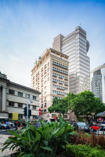 a tall building in a city with cars at Hotel Metropole in Macau
