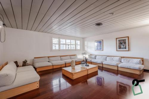 a large living room with couches and a table at HOTIDAY Room Collection - Sarzana in Sarzana