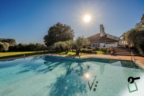 a large swimming pool in front of a house at HOTIDAY Room Collection - Sarzana in Sarzana