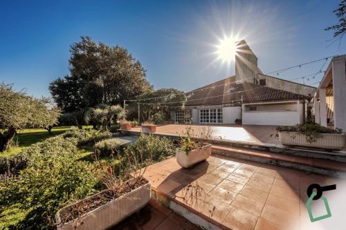 a house with the sun shining on the roof at HOTIDAY Room Collection - Sarzana in Sarzana
