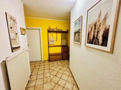 a hallway with yellow walls and a door to a room at Ferienhaus Usedom - Haus Andrea - 300Meter zur Ostsee in Ostseebad Koserow