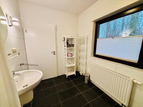 a bathroom with a sink and a large window at Ferienhaus Usedom - Haus Andrea - 300Meter zur Ostsee in Ostseebad Koserow
