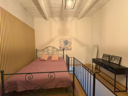 a small bedroom with a bed and a piano at Casa Nico and Vico in Scalea