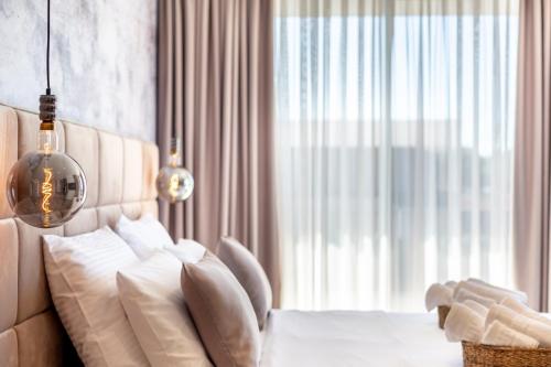 a bedroom with a bed with white pillows and a window at Fly Room - S5 - MPolo in Medulin