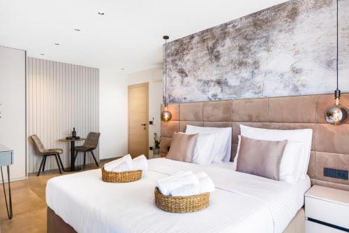 a bedroom with a large white bed with baskets on it at Fly Room - S5 - MPolo in Medulin