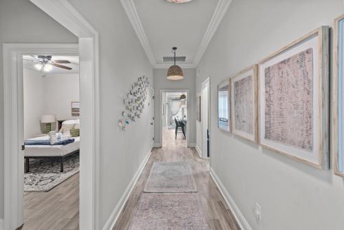 a hallway of a home with white walls at Aurora Haven - TV in each room in Shreveport