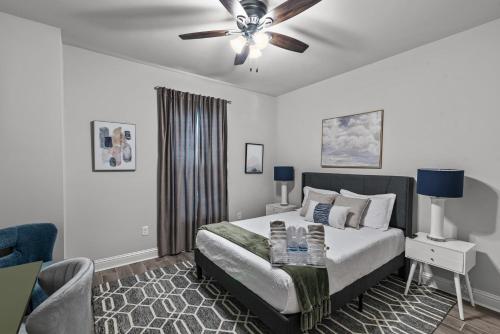 a bedroom with a bed and a ceiling fan at Aurora Haven - TV in each room in Shreveport