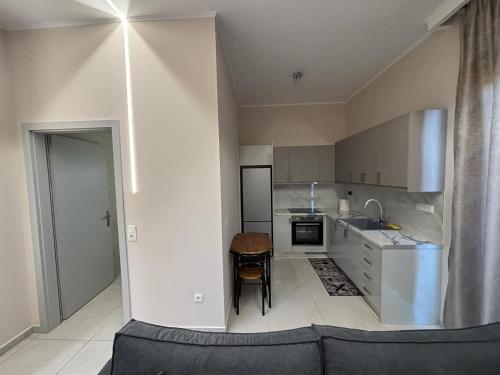 a kitchen with a couch and a table in it at Elias house in Tríkala