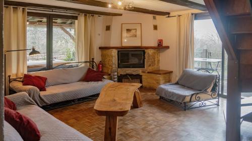 un salon avec un canapé et une cheminée dans l'établissement Owi - Idyllisches Ferienhaus inmitten der Natur, à Payrac