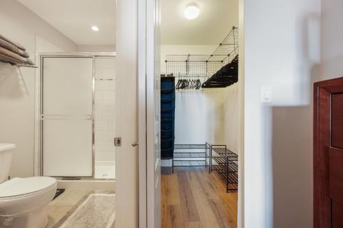 a bathroom with a toilet and a walk in closet at Your Urban Oasis in the Heart of Little Italy in San Diego