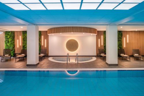 a pool in the lobby of a hotel with a large building at Munich Marriott Hotel in Munich