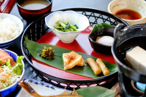 a plate of food on a table with food at 鹿鳴館 in Yurihama
