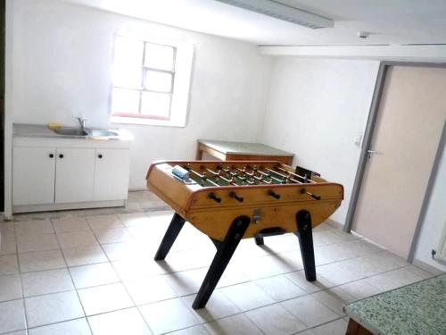 a table in the middle of a room at CHALET, GITE DE GROUPE - ATC ROUTES DU MONDE à BUSSANG - 32 couchages in Bussang