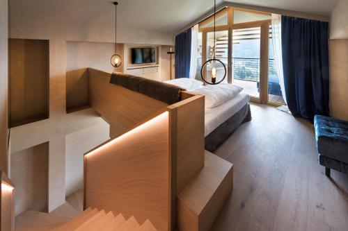 a hotel room with a bed and a mirror at Hotel Valentinerhof in Siusi