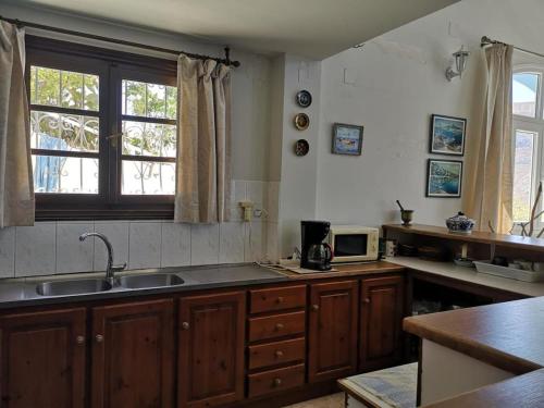 a kitchen with a sink and a window at Sea View 180' in Kalymnos