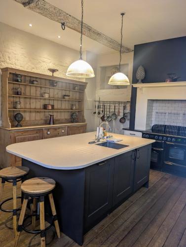 a large kitchen with a large island in the middle at Five Star Luxury - Oxnead Hall in Burgh next Aylsham