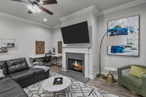 a living room with a couch and a fireplace at Aurora Haven - TV in each room in Shreveport