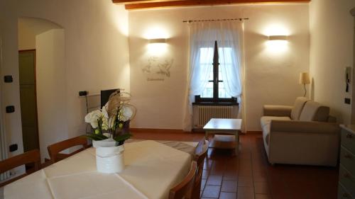 a living room with a table with flowers on it at Residence La Colombera in Riva del Garda