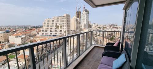 a balcony with a view of a city at Savyon View Royal Suites - Alefimmoed in Jerusalem