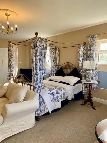 a bedroom with two beds and a couch at Rossmanagher House in Bunratty