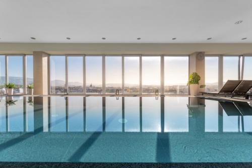 a swimming pool with a view of a building at Holiday Inn Zilina by IHG in Žilina