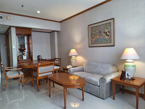 a living room with a couch and a table at Hotel Sahid Jaya Solo in Solo