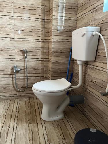 a bathroom with a toilet and a shower at Beltola serenity homestay in Guwahati