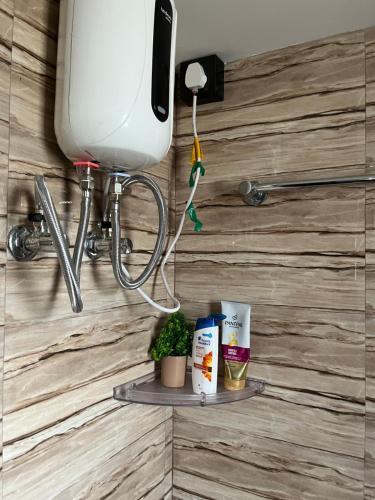 a shelf on a bathroom wall with aperature at Beltola serenity homestay in Guwahati