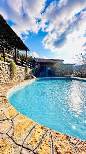 a swimming pool with blue water in front of a building at Casa Paloma Private Villa in Cicerale
